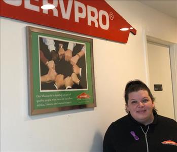 Female standing under a SERVPRO sign. 