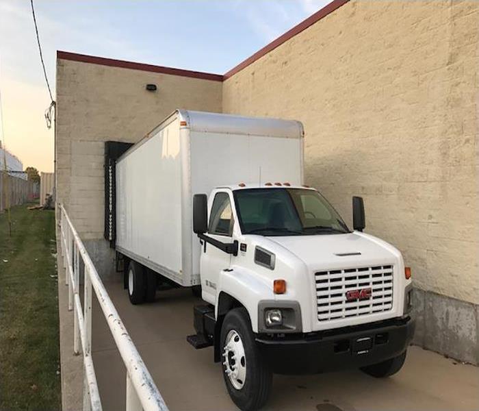 A white truck parked at a loading dock