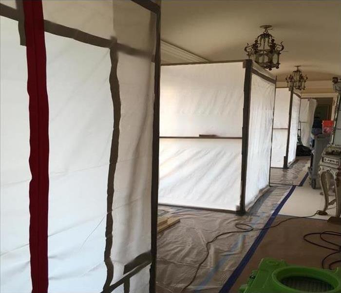 White plastic room dividers with SERVPRO equipment on the floor