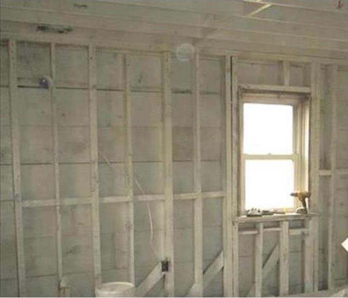 A bare wall without drywall after a fire damage