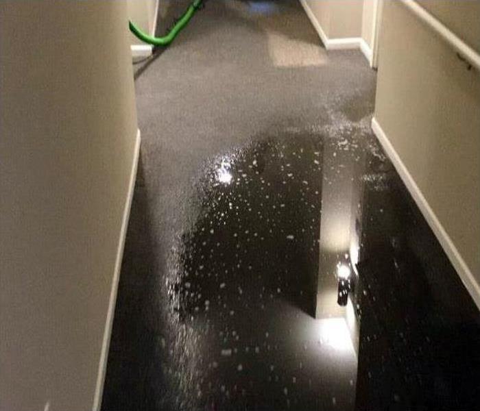 Standing water damage in a commercial hallway. 
