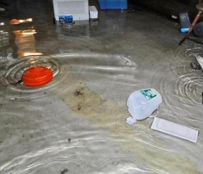 Standing water in basement; possessions on floor