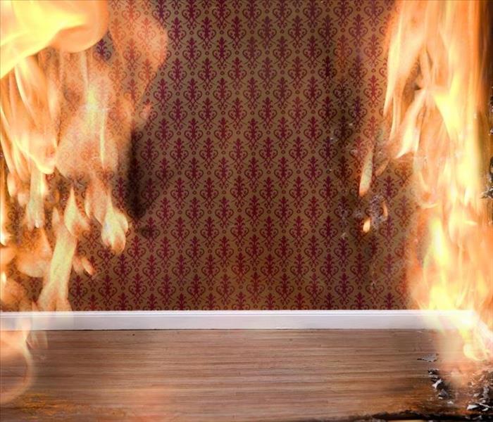 Burning fire in a room with red wallpaper 
