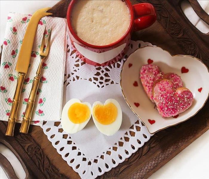 Heart shaped eggs, cookies, and coffee cup
