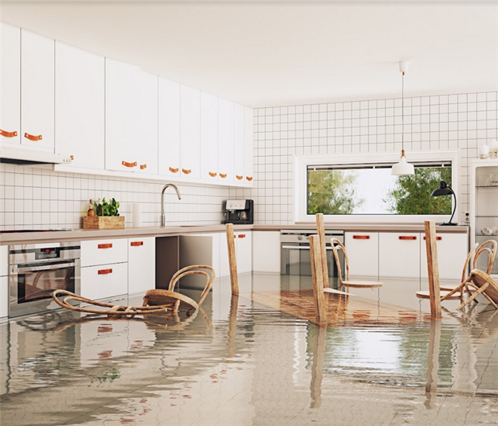 a flooded kitchen with furniture floating