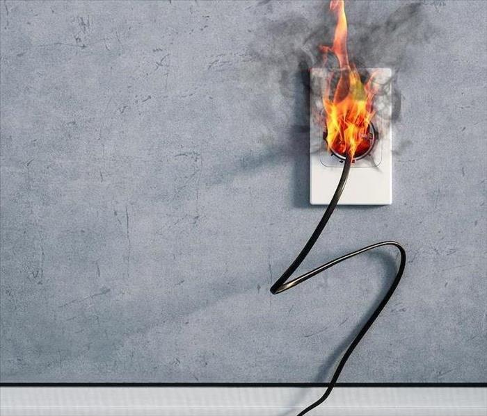 Fire on a plug plugged into the wall 