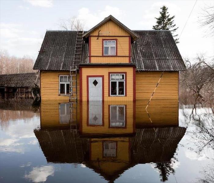 Yellow home floating in standing water